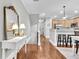 Hallway with hardwood floors and stylish console table leads to the kitchen at 622 Windermere Blvd # D, Charleston, SC 29407