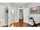 Hallway view with hardwood floors leads to a bathroom and a staircase, creating an open and inviting transition at 622 Windermere Blvd # D, Charleston, SC 29407
