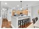 Open kitchen and dining area with bar seating, wood cabinets and hardwood floors at 622 Windermere Blvd # D, Charleston, SC 29407