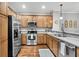 Modern kitchen features stainless steel appliances, wood cabinets, and a sleek countertop at 622 Windermere Blvd # D, Charleston, SC 29407