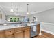 Kitchen sink area with stainless steel appliances, wood cabinets, and pendant lighting at 622 Windermere Blvd # D, Charleston, SC 29407
