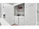 Convenient laundry closet with white washer and dryer units and storage shelves at 622 Windermere Blvd # D, Charleston, SC 29407