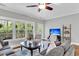 Bright living room features large windows, hardwood floors, and a ceiling fan at 622 Windermere Blvd # D, Charleston, SC 29407