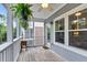Screened-in porch perfect for enjoying the outdoors with hanging ferns and rustic decor at 622 Windermere Blvd # D, Charleston, SC 29407