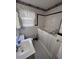 Cozy bathroom featuring a walk-in tub, checkered floors, and a charming window at 686 W Pine St, Varnville, SC 29944