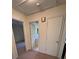 Hallway featuring a bathroom with vintage flooring, doors, and access to rooms at 686 W Pine St, Varnville, SC 29944