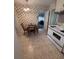 Charming eat-in kitchen with vintage wallpaper and wood table at 686 W Pine St, Varnville, SC 29944