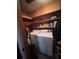 Functional laundry room with washer, dryer, and shelving for storage at 686 W Pine St, Varnville, SC 29944
