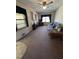 Cozy living room features wood paneling, plush carpet, and a comfortable floral couch at 686 W Pine St, Varnville, SC 29944