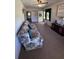 Comfortable living room with floral sofa, wood paneling, and vintage decor at 686 W Pine St, Varnville, SC 29944