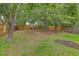 A lush backyard with trees and a wooden fence is ideal for relaxing or entertaining at 7300 Suncatcher Dr, Hanahan, SC 29410