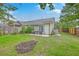 Spacious backyard with a patio and outdoor furniture, surrounded by a wooden fence at 7300 Suncatcher Dr, Hanahan, SC 29410