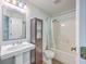 Bathroom featuring a pedestal sink, wood cabinet, and tub and shower with light blue tile at 7300 Suncatcher Dr, Hanahan, SC 29410