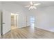 Light-filled bedroom with wood floors, white walls, and a doorway to a walk-in closet at 7300 Suncatcher Dr, Hanahan, SC 29410