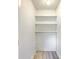 A small closet with white walls and shelving at 7300 Suncatcher Dr, Hanahan, SC 29410