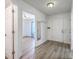Bright entryway with modern flooring, coat rack, and open access to other rooms at 7300 Suncatcher Dr, Hanahan, SC 29410