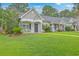 Well-manicured lawn with landscaped home exteriors and welcoming front porches at 7300 Suncatcher Dr, Hanahan, SC 29410