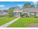 Charming single-story home features a cozy front porch and well-manicured lawn at 7300 Suncatcher Dr, Hanahan, SC 29410
