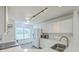 White kitchen with white countertops and white cabinets with gray wood flooring and stainless steel appliances at 7300 Suncatcher Dr, Hanahan, SC 29410