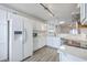 Bright white kitchen with stainless steel appliances, bar height countertop, and an open floor plan at 7300 Suncatcher Dr, Hanahan, SC 29410