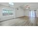 Bright living room features modern flooring, a skylight, and natural light at 7300 Suncatcher Dr, Hanahan, SC 29410