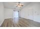An open concept living room with gray wood flooring and a door that leads to the outside at 7300 Suncatcher Dr, Hanahan, SC 29410