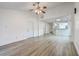 Spacious living room with gray wood flooring leading into the kitchen and other parts of the home at 7300 Suncatcher Dr, Hanahan, SC 29410