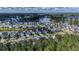 Wide aerial shot displaying the neighborhood with waterfront views, trees and well maintained lawns at 105 Harbor Trace Ln, Summerville, SC 29486
