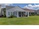 Backyard view featuring a screened-in patio with an overhead pergola and a well manicured lawn at 105 Harbor Trace Ln, Summerville, SC 29486