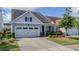 Charming home with a well-manicured front yard and an attached two-car garage at 105 Harbor Trace Ln, Summerville, SC 29486