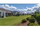 Beautiful view of the rear of the property overlooking a large grassy backyard and screened porches at 105 Harbor Trace Ln, Summerville, SC 29486