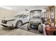Spacious two car garage with a white SUV and an EZGO golf cart at 105 Harbor Trace Ln, Summerville, SC 29486