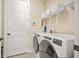 Laundry room with modern washer and dryer and ample shelving for storage at 105 Harbor Trace Ln, Summerville, SC 29486