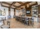 Stylish lounge area with a long island bar, open shelving, TV, seating, and modern decor, perfect for casual gatherings at 105 Harbor Trace Ln, Summerville, SC 29486