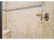 Walk-in shower with neutral-toned tile, built-in bench and a shower head with wand at 105 Harbor Trace Ln, Summerville, SC 29486