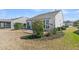 Backyard features a small patio area, complemented by lush shrubs and well-maintained garden beds at 109 Billowing Sails St, Summerville, SC 29486