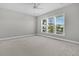 Neutral bedroom with carpet, neutral walls, ceiling fan, and window view of neighborhood at 109 Billowing Sails St, Summerville, SC 29486