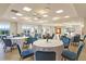 Elegant event space with tables set, perfect for celebrations and gatherings, enhanced by abundant natural light at 109 Billowing Sails St, Summerville, SC 29486