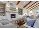 Stylish fireplace featuring marble surround and built-in shelving, complemented by exposed beams for a warm ambiance at 109 Billowing Sails St, Summerville, SC 29486