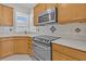 Bright kitchen showcasing stainless steel oven, built in microwave, tile backsplash, and countertops at 109 Billowing Sails St, Summerville, SC 29486
