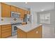 Modern kitchen with stainless steel appliances, a kitchen island, and adjacent breakfast nook at 109 Billowing Sails St, Summerville, SC 29486