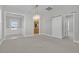 Spacious living room with modern lighting, open layout, and access to kitchen and other rooms via sliding barn door at 109 Billowing Sails St, Summerville, SC 29486