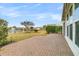 Brick patio with retractable awning overlooking well-maintained yard with lake views at 109 Billowing Sails St, Summerville, SC 29486