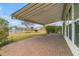 Brick patio with retractable awning overlooking well-maintained yard with lake views at 109 Billowing Sails St, Summerville, SC 29486