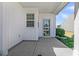 Covered patio showcasing white siding, a screened door, and a view of the home's exterior and landscaping at 109 Billowing Sails St, Summerville, SC 29486
