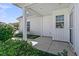 View of the covered patio with white columns, white siding, complemented by well-maintained landscaping at 109 Billowing Sails St, Summerville, SC 29486