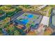 Aerial view of a community pickleball court with players and landscaped surroundings for outdoor activities at 109 Billowing Sails St, Summerville, SC 29486