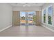 Bright sunroom with tile flooring, ceiling fan and sliding glass doors offer views of a beautiful lake and landscape at 109 Billowing Sails St, Summerville, SC 29486