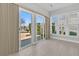 Bright sunroom with tile flooring, ceiling fan, and sliding glass doors overlooking a picturesque lake setting at 109 Billowing Sails St, Summerville, SC 29486