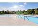 Beautiful zero entry community pool with poolside seating and lush landscaping; ideal for relaxation at 109 Billowing Sails St, Summerville, SC 29486